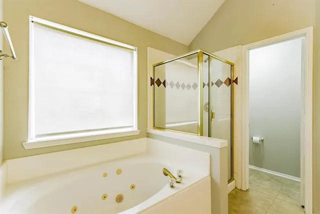 a bathroom with a bathtub and a shower