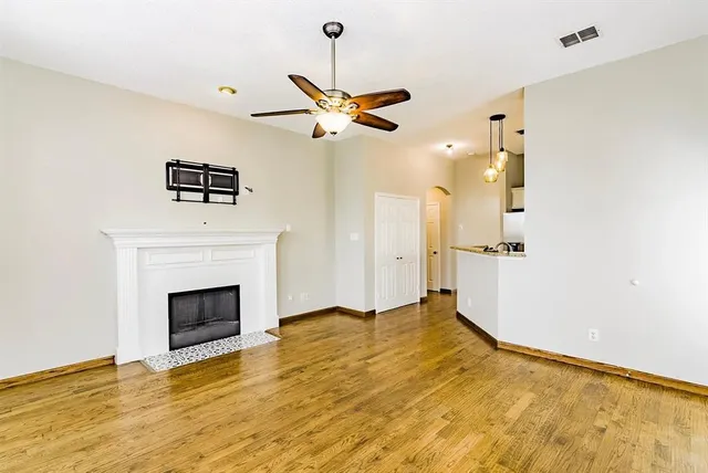 a view of empty room with a fireplace