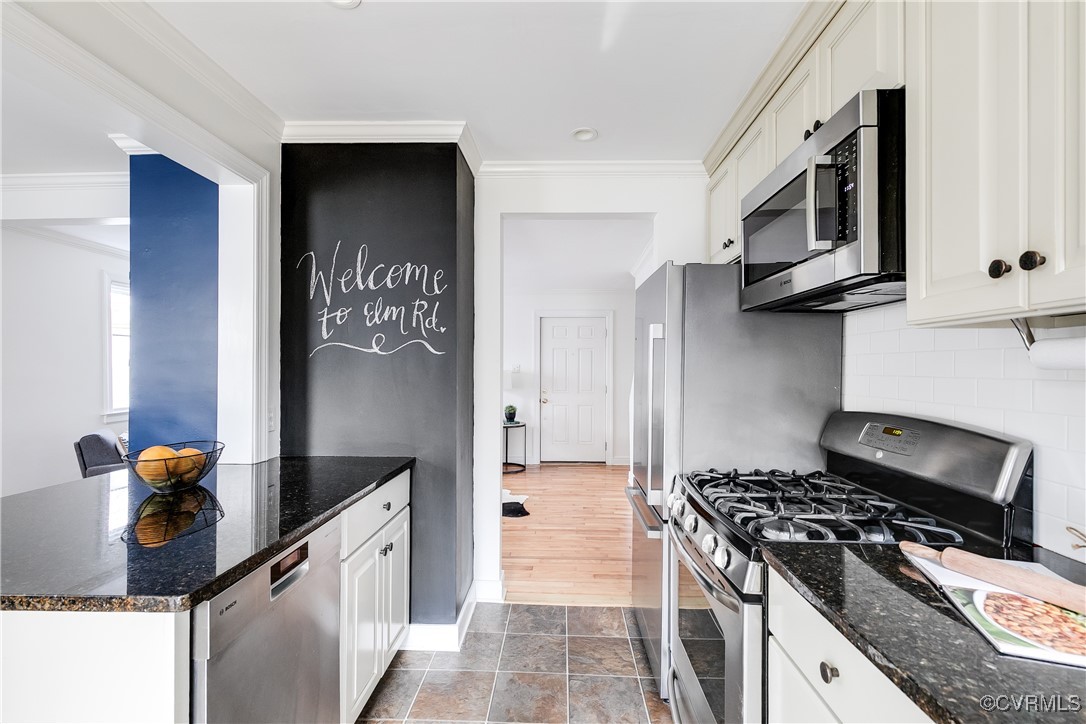 8941 Elm Road Richmond, VA 23235 - Photo 11 of 35 a kitchen with stainless steel appliances granite countertop a stove and a microwave