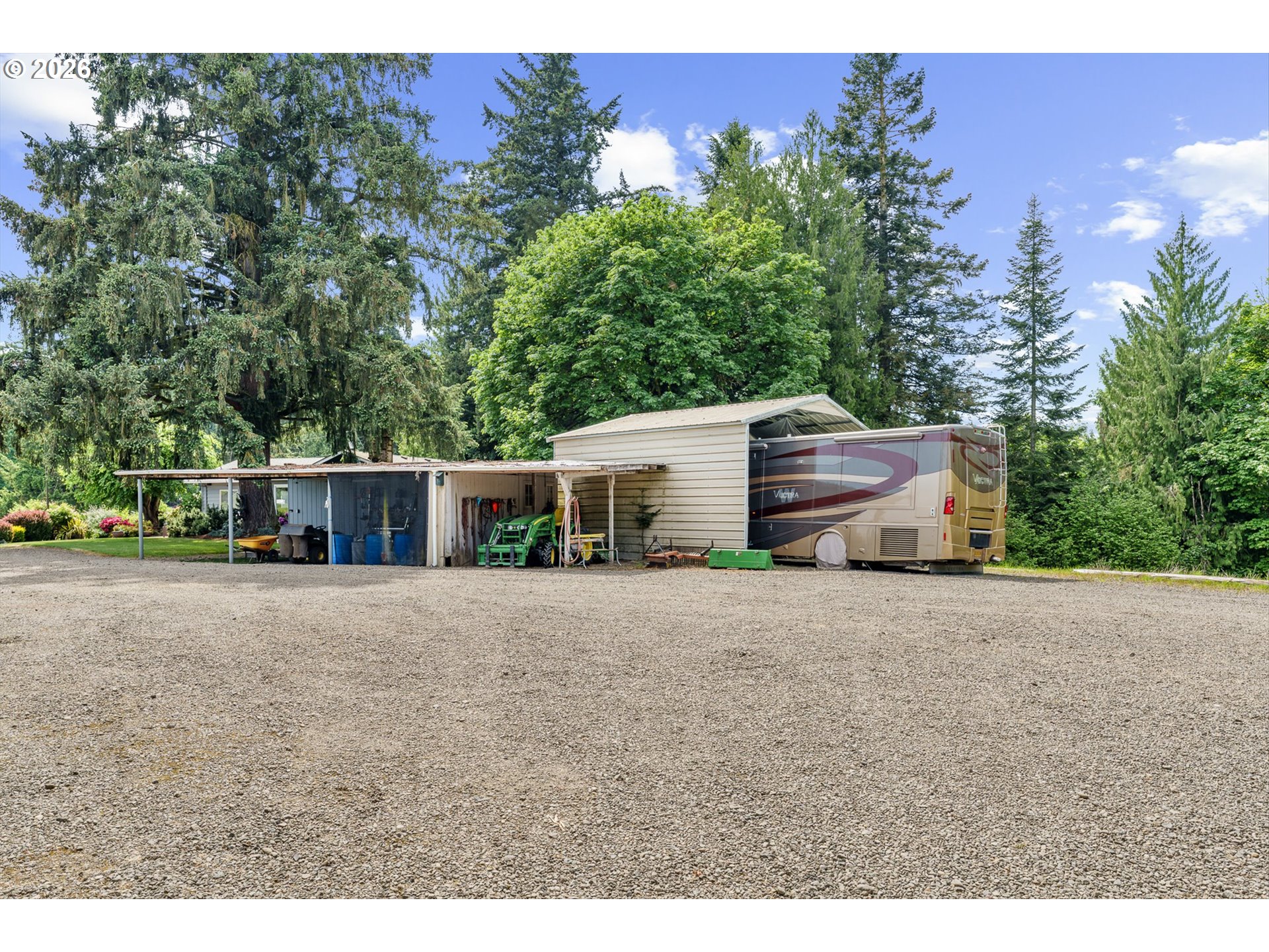 12737 Northeast Cedarbrook Road Aurora, OR 97002 - Photo 32 of 48 a front view of a house with a yard and garage