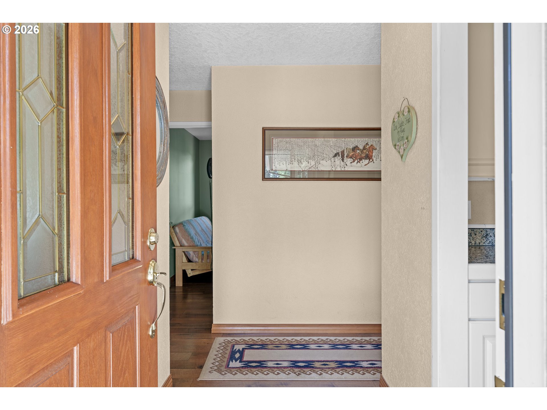 12737 Northeast Cedarbrook Road Aurora, OR 97002 - Photo 5 of 48 a view of a hallway with wooden floor and chair