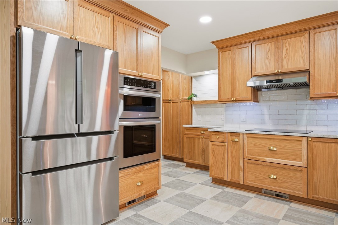 1515 Barlow Road Hudson, OH 44236 - Photo 7 of 31 Completely renovated kitchen with custom cabinetry, induction cooktop, stainless steel appliances, and porcelain tile flooring!