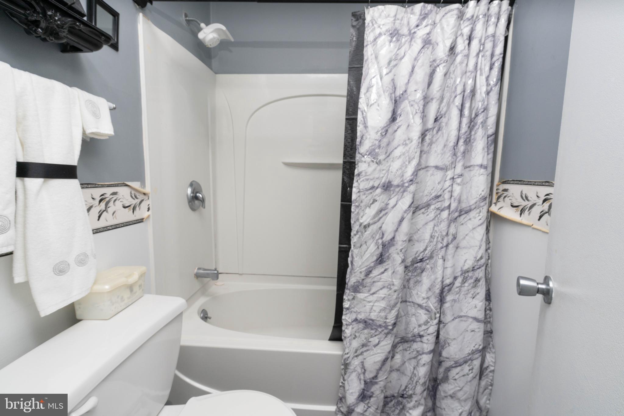 24 Magnolia Court Sicklerville, NJ 08081 - Photo 18 of 22 a bathroom with a bathtub and shower