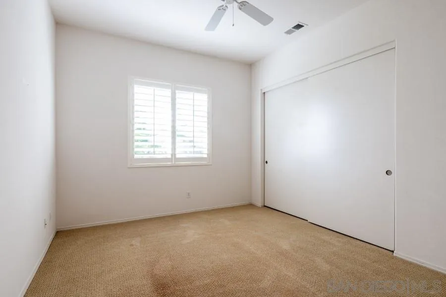 15076 Eastvale Road Poway, CA 92064 - Photo 16 of 35 an empty room with a window and a fan