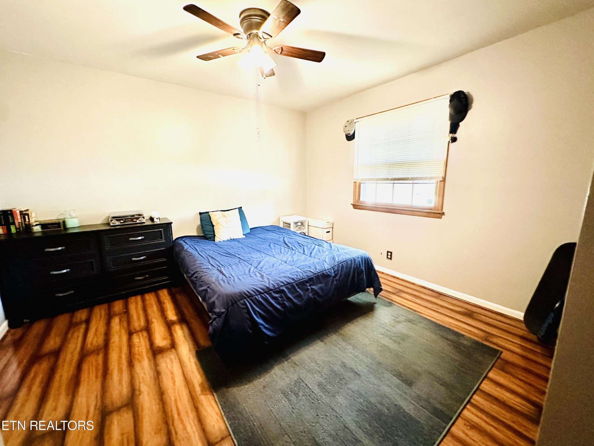 4428 Royalview Road Knoxville, TN 37921 - Photo 12 of 18 a bedroom with a bed and wooden floor