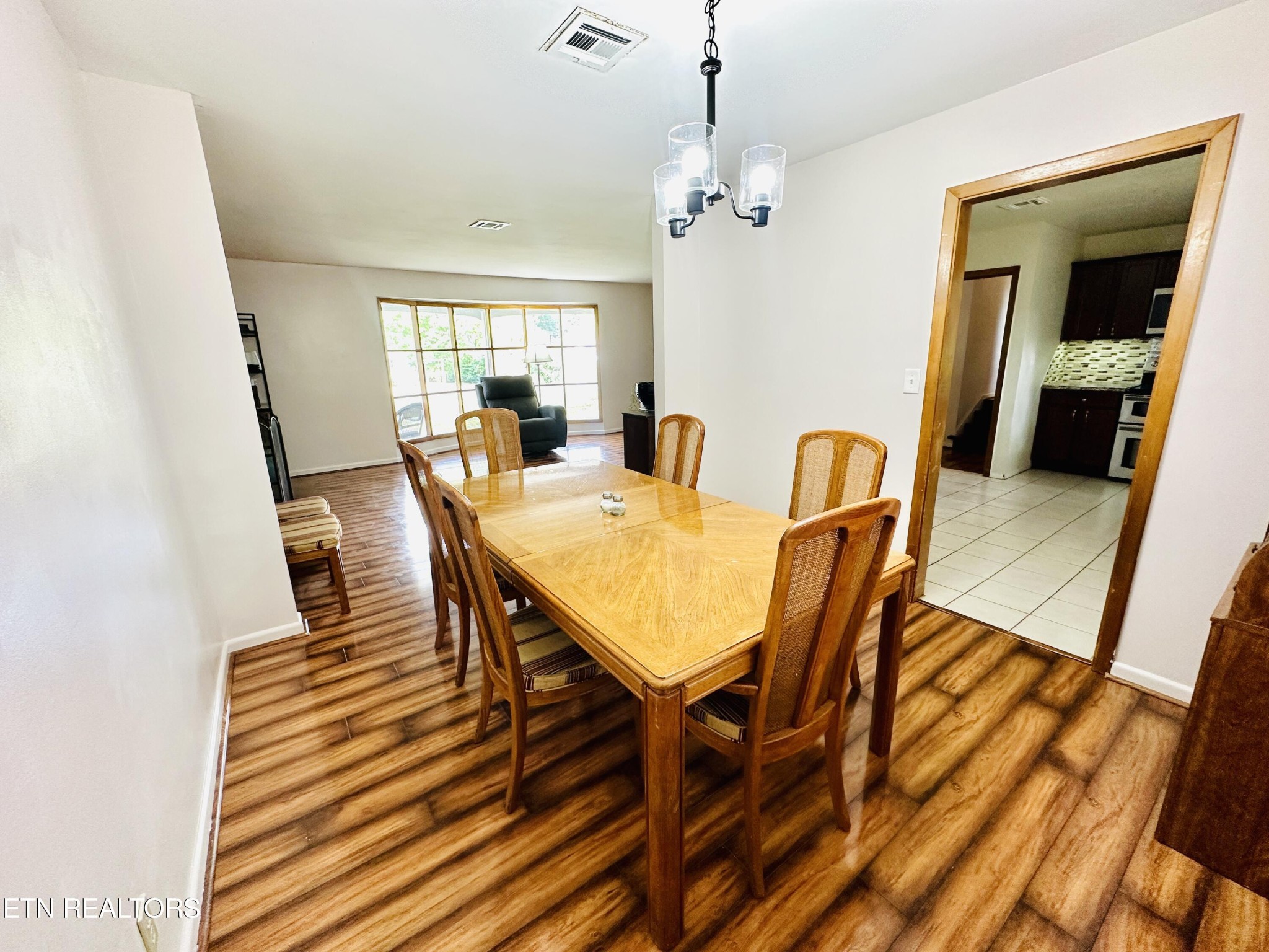 4428 Royalview Road Knoxville, TN 37921 - Photo 5 of 18 a view of a dining room with furniture and wooden floor