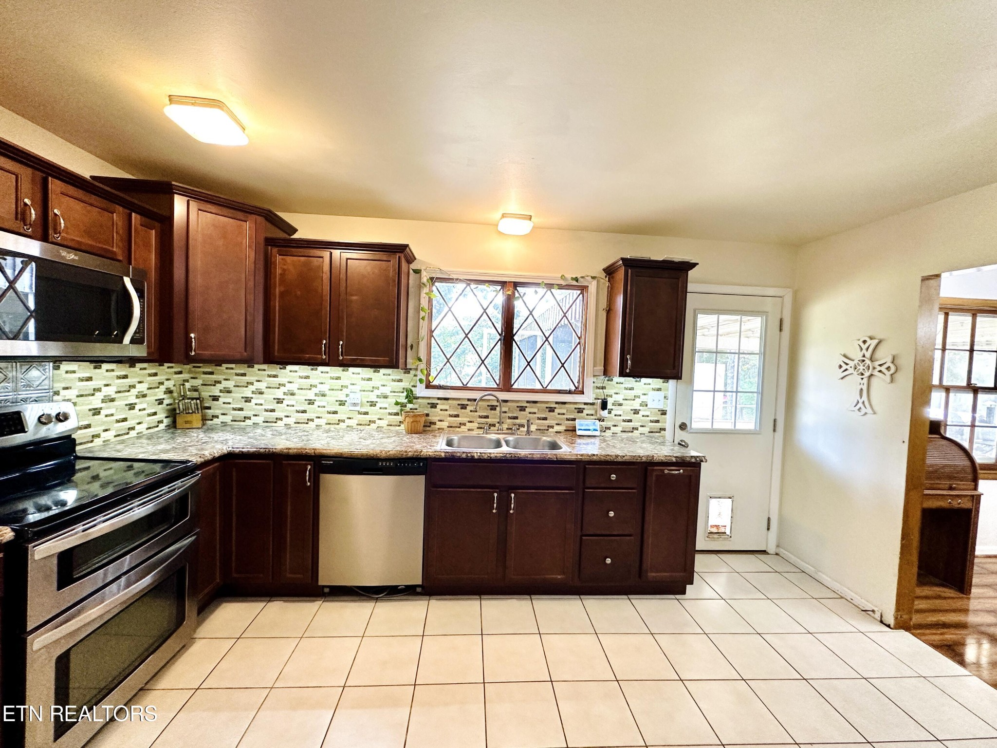 4428 Royalview Road Knoxville, TN 37921 - Photo 7 of 18 a kitchen with stainless steel appliances granite countertop a stove and a refrigerator