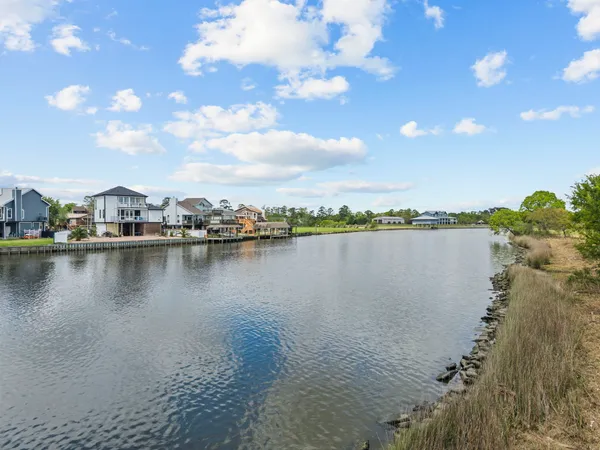 a view of a lake with houses in the background