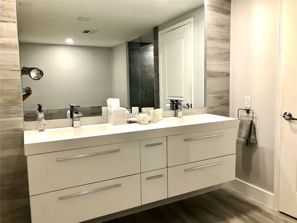 a bathroom with 2 sink and a mirror