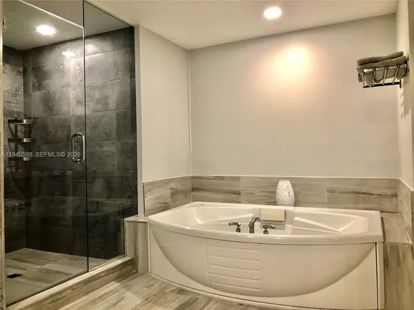 a bath tub sitting next to a shower