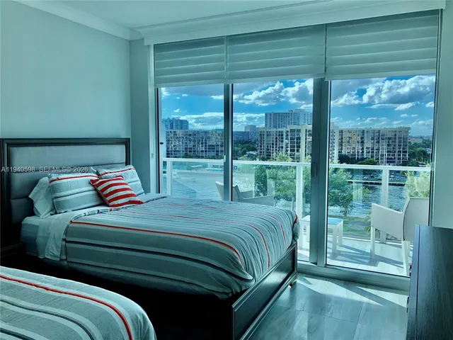 a bedroom with a bed and a large window