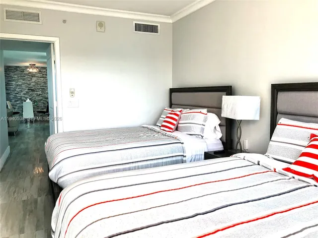 a bedroom with a bed and a lamp