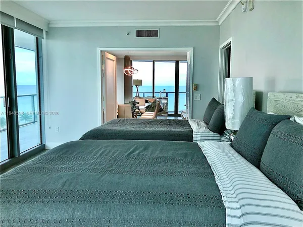 a large bedroom with a bed and a large window