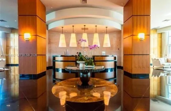 a dining room with chandelier a table and chairs