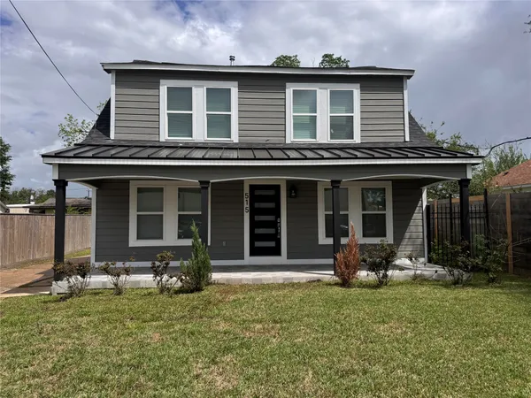 a front view of a house with a garden and porch