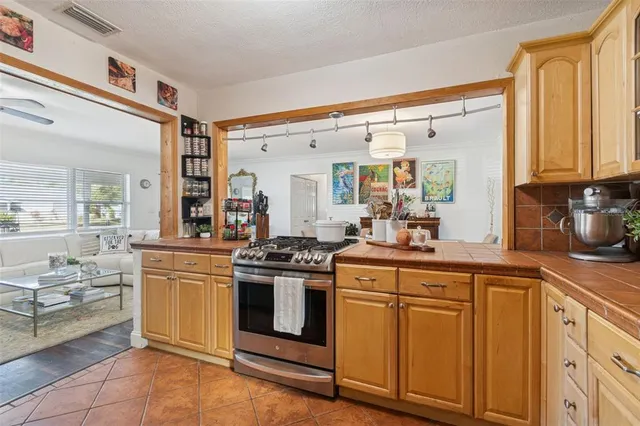 a kitchen with stainless steel appliances granite countertop a stove and a sink
