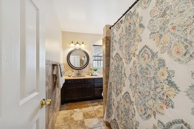 a view of a bathroom with a sink and a mirror
