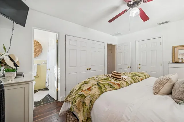 a bedroom with a bed and a flat screen tv