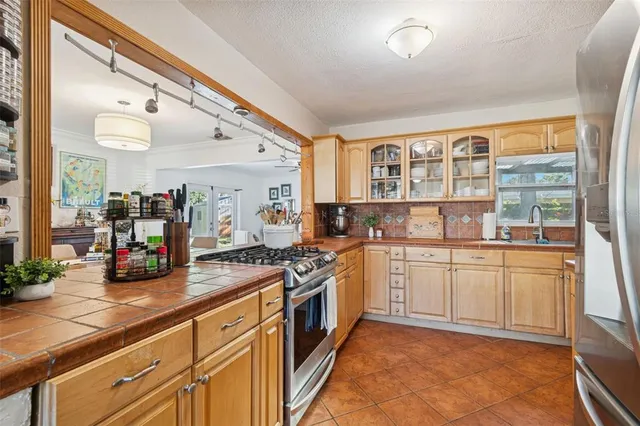 a kitchen with stainless steel appliances granite countertop a stove and cabinets