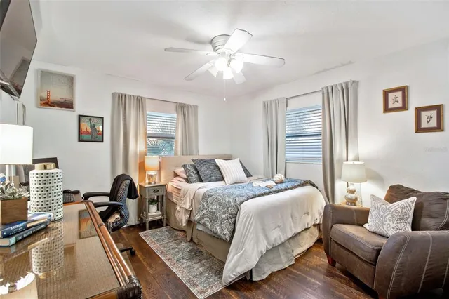 a bedroom with a large bed and a flat screen tv