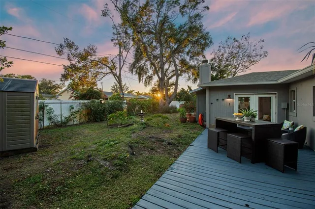 a view of a cafe with a table and chairs under an umbrella