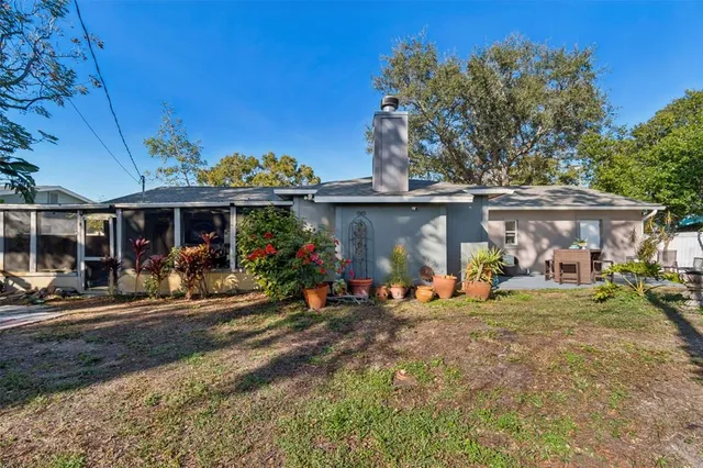 a view of a patio with table and chairs and potted plants