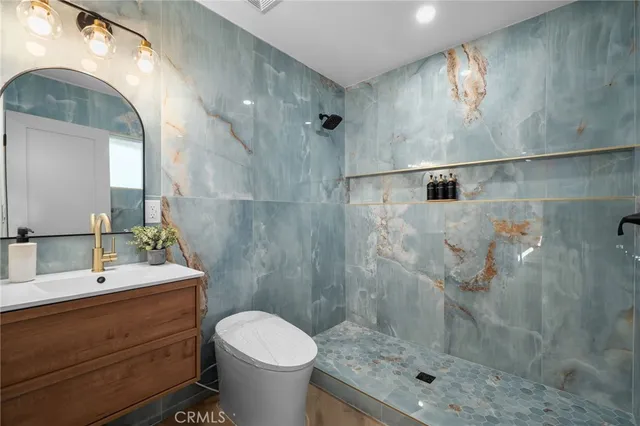 a bathroom with a sink mirror and toilet