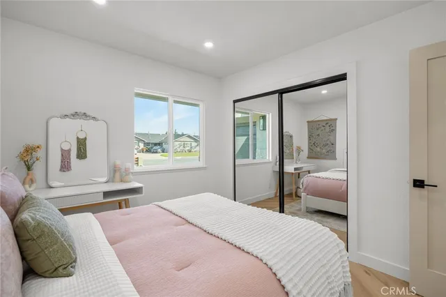 a bedroom with a bed and wooden floor