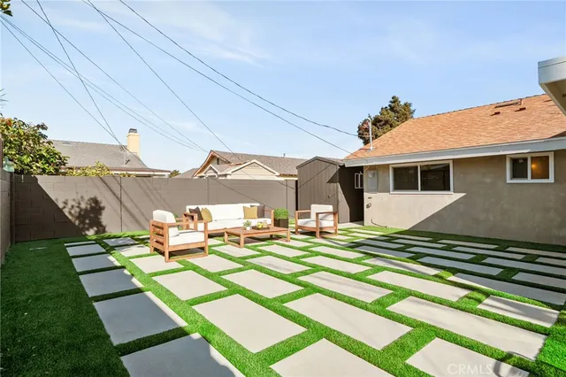 a front view of a house with a yard table and chairs