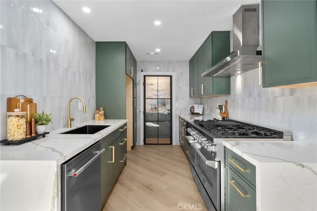 a kitchen with granite countertop a sink stove and cabinets