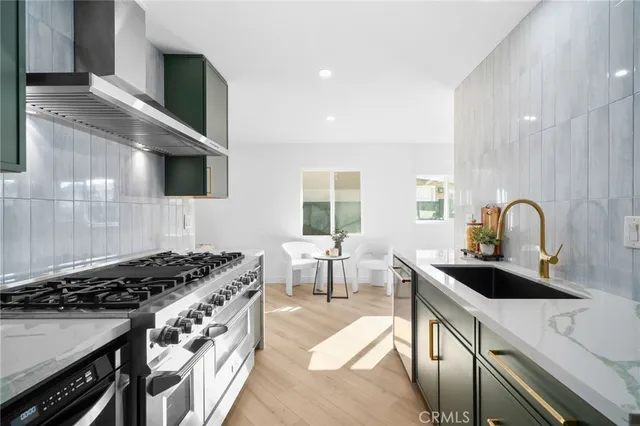 a kitchen with granite countertop a stove and a sink