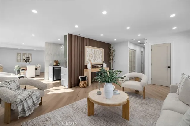 a living room with furniture a potted plant and a fireplace
