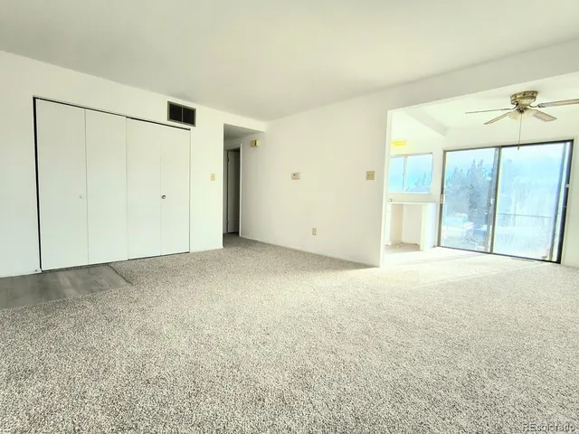 a view of an empty room with a window