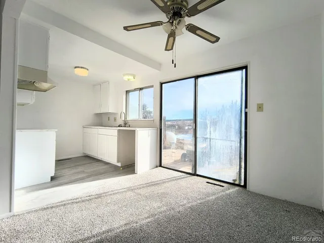 a view of a kitchen with a sink and a window