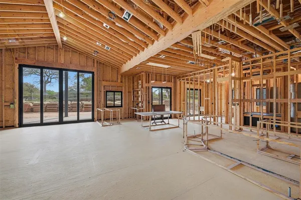 a view of a hall with wooden floor and a rug