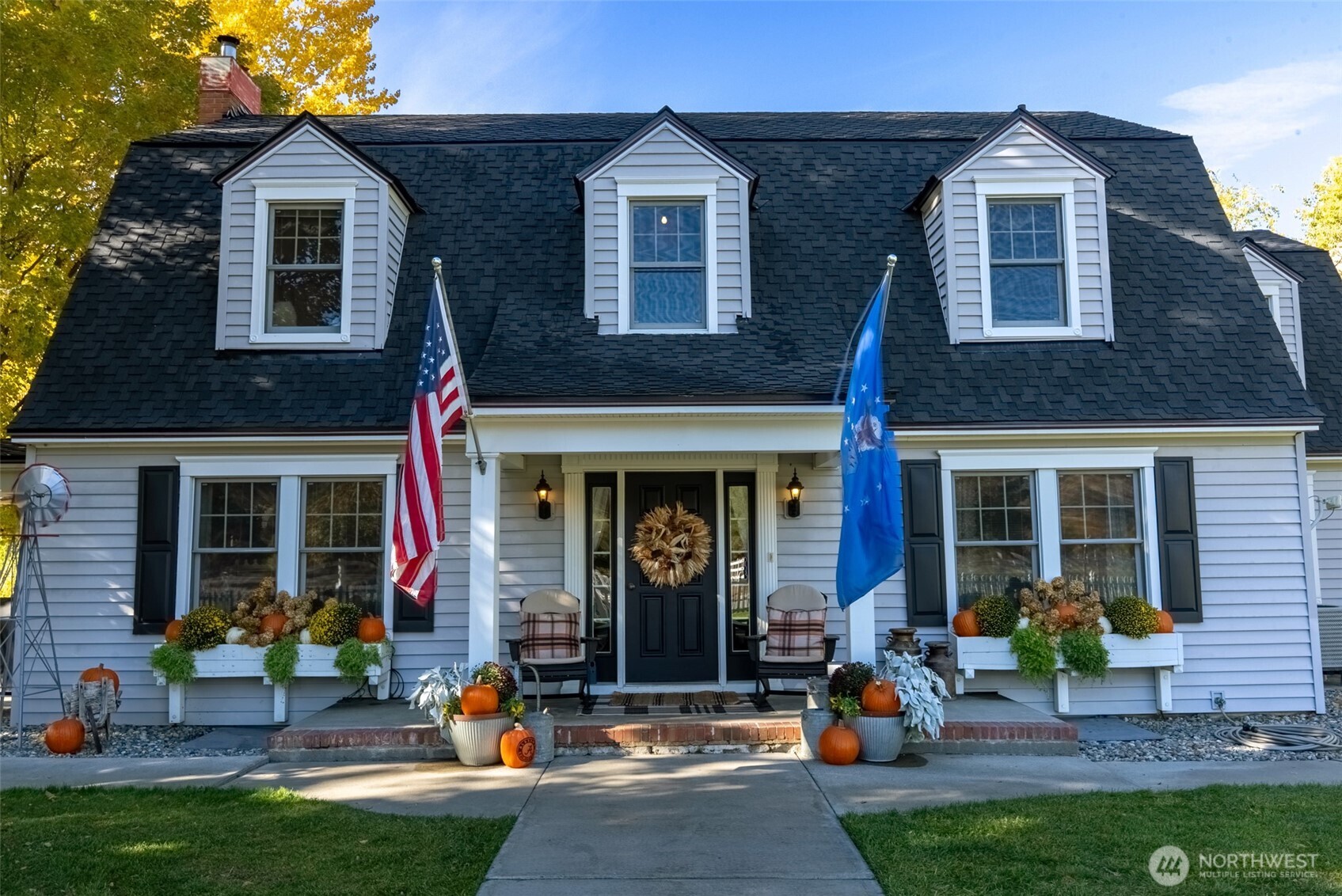 a front view of a house with outdoor seating