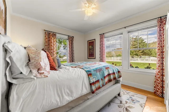 a bed sitting in a bedroom next to a window