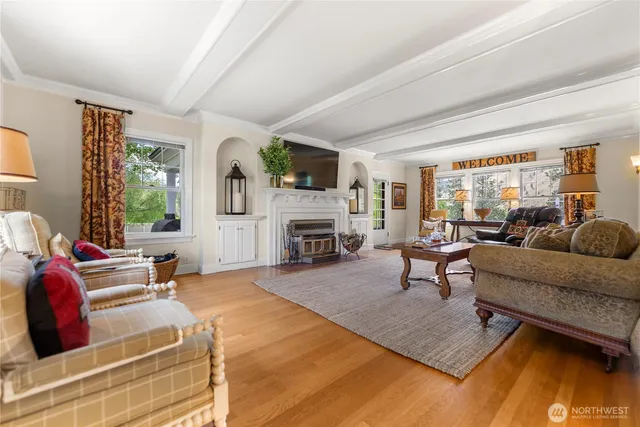 a living room with furniture large window and a fireplace