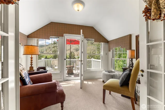 a bedroom with furniture and a large window