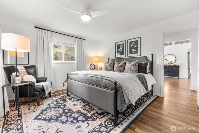 a bedroom with bed and wooden floor