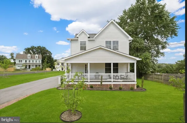a front view of a house with a yard table and chairs