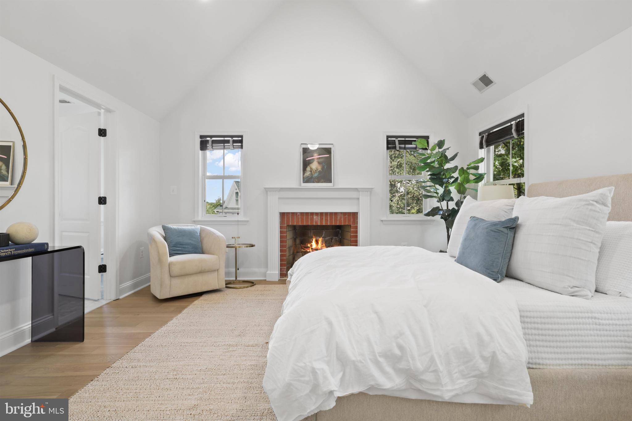 438 Ethan Allen Avenue Takoma Park, MD 20912 - Photo 12 of 47 a bedroom with a large bed and a fireplace