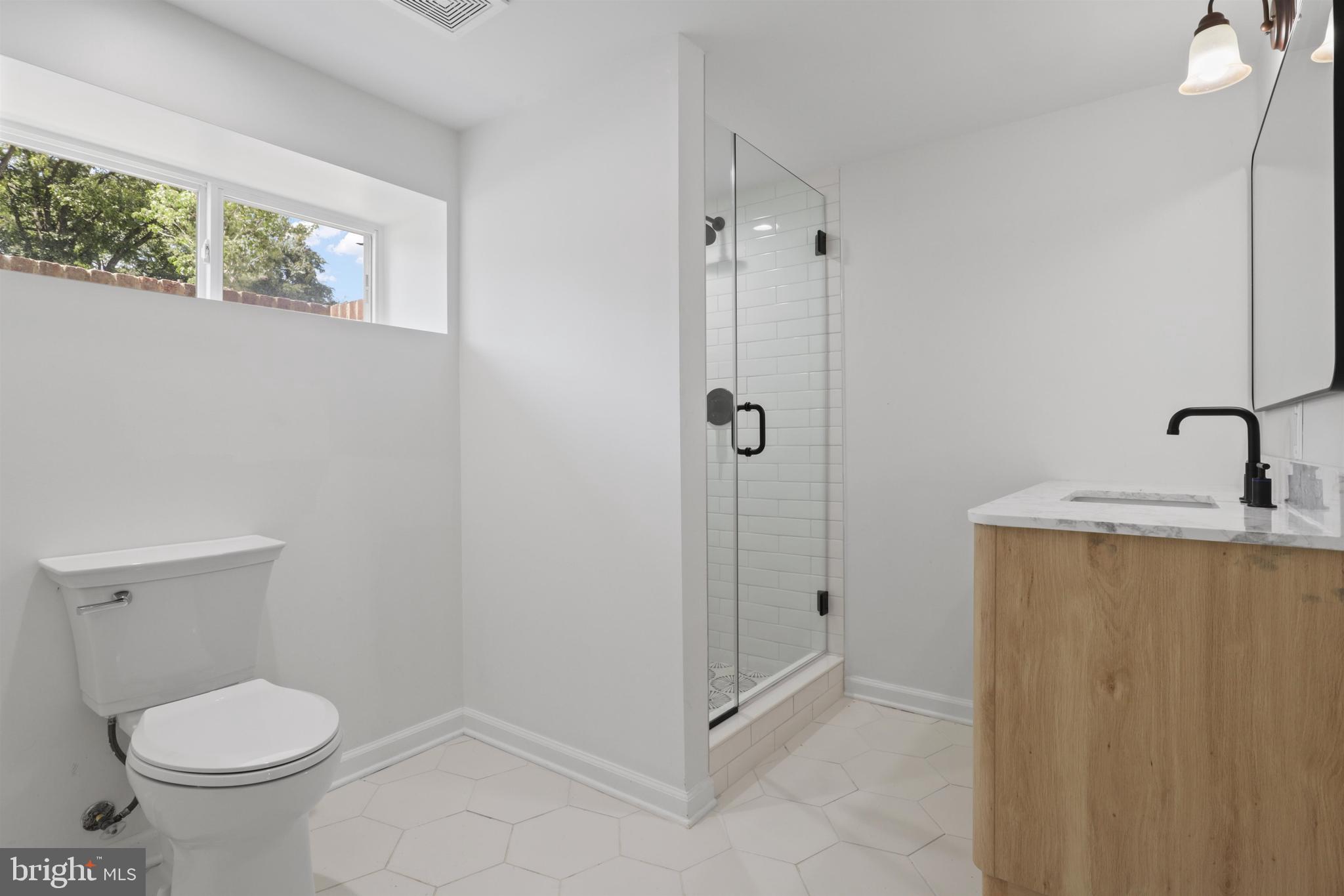 438 Ethan Allen Avenue Takoma Park, MD 20912 - Photo 16 of 47 a bathroom with a granite countertop sink a toilet and shower