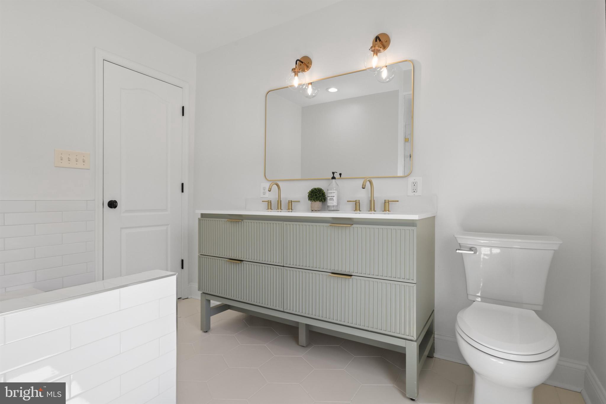 438 Ethan Allen Avenue Takoma Park, MD 20912 - Photo 23 of 47 a bathroom with a sink toilet vanity and tub