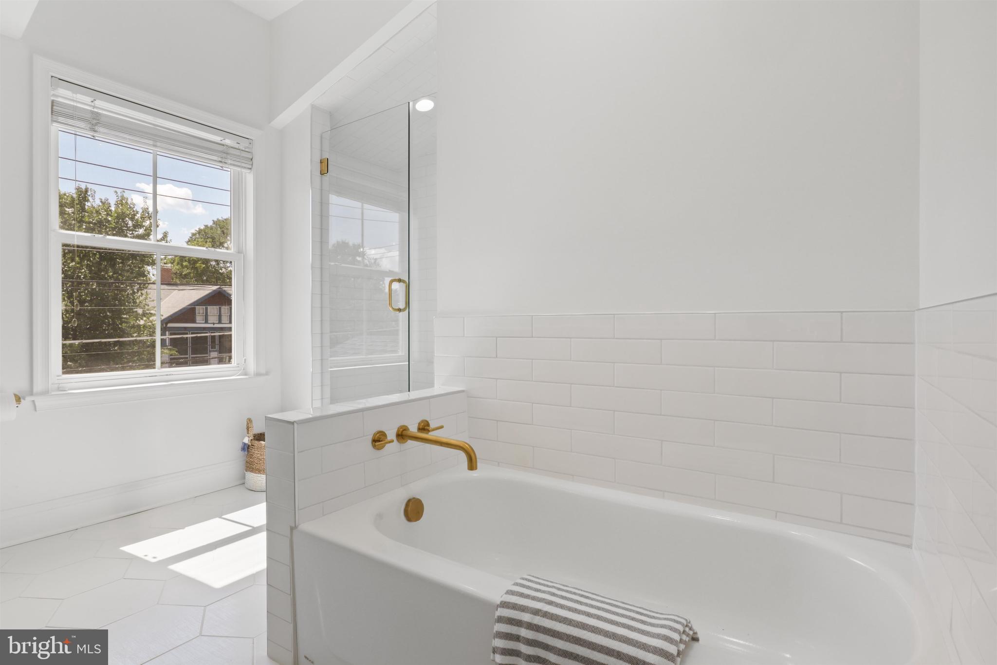 438 Ethan Allen Avenue Takoma Park, MD 20912 - Photo 24 of 47 a bathroom with a bathtub and a shower