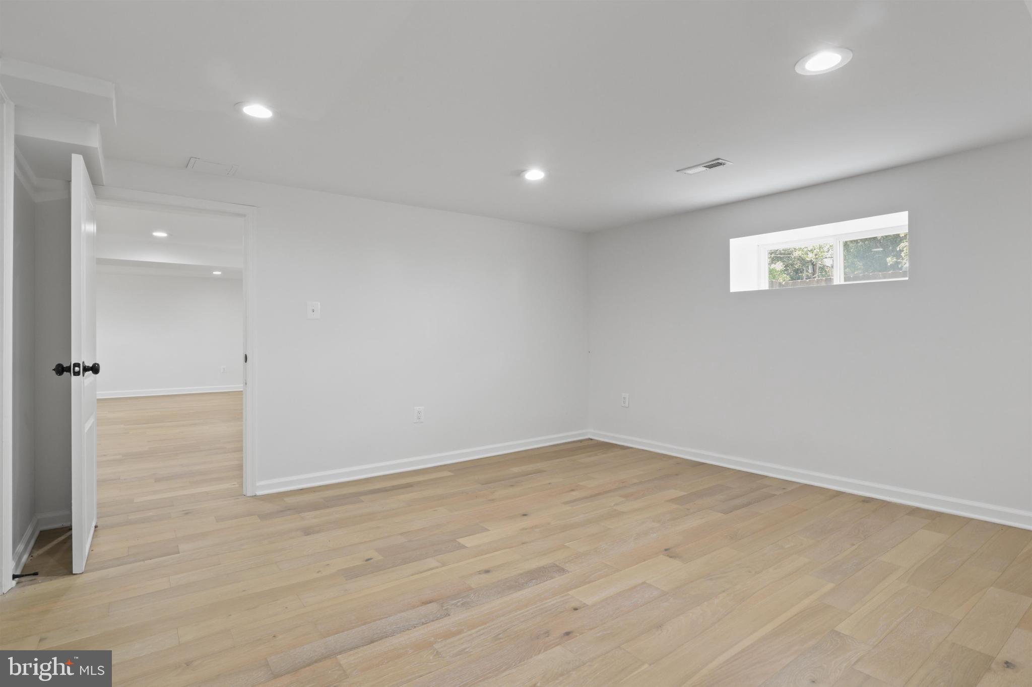 438 Ethan Allen Avenue Takoma Park, MD 20912 - Photo 29 of 47 an empty room with wooden floor and windows