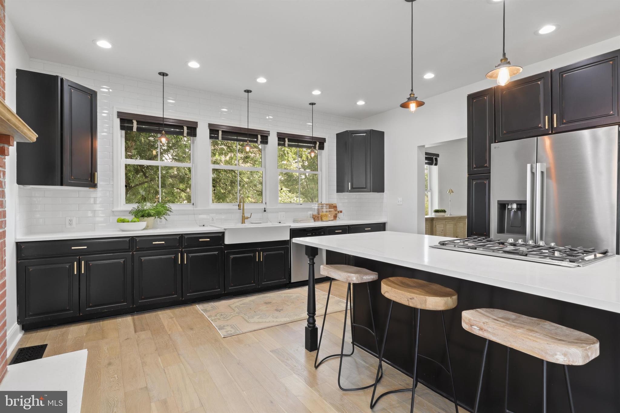 438 Ethan Allen Avenue Takoma Park, MD 20912 - Photo 8 of 47 a large kitchen with kitchen island granite countertop a large window and chairs