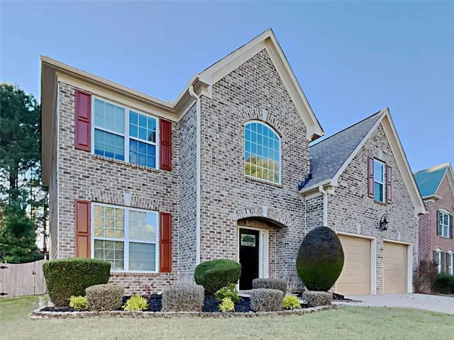 a front view of a house with yard