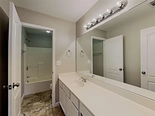 a bathroom with a double vanity sink and mirror