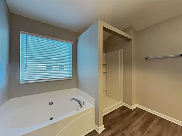 a bathroom with a tub and a window